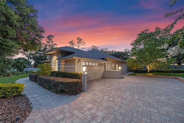 5102 Round Tree Ct, Orlando, FL 32819 - view of front of home featuring stucco siding, an attached garage, and driveway