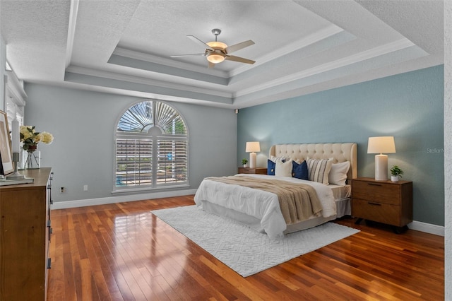 5102 Round Tree Ct, Orlando, FL 32819 - bedroom featuring a raised ceiling, hardwood / wood-style flooring, crown molding, ceiling fan, and a textured ceiling