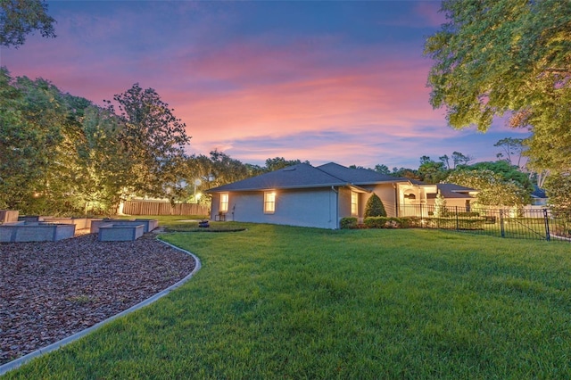 5102 Round Tree Ct, Orlando, FL 32819 - back of property at dusk featuring a fenced backyard, stucco siding, and a garden