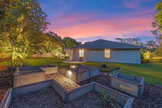 5102 Round Tree Ct, Orlando, FL 32819 - back of property at dusk featuring a vegetable garden