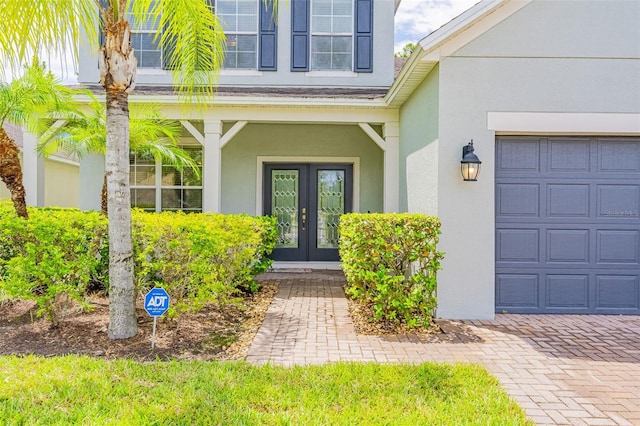 1639 Balsam Willow Trl, Orlando, FL 32825 - entrance to property featuring french doors, stucco siding, and a garage