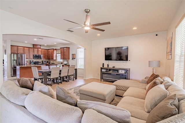 1639 Balsam Willow Trl, Orlando, FL 32825 - living area with arched walkways, ceiling fan, recessed lighting, and light tile patterned floors