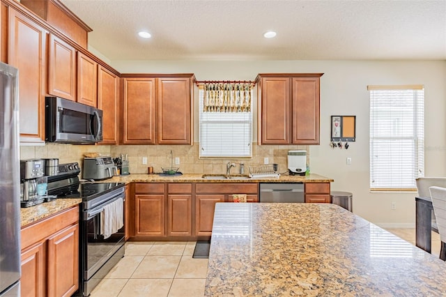 1639 Balsam Willow Trl, Orlando, FL 32825 - kitchen with electric range, dishwasher, decorative backsplash, plenty of natural light, and recessed lighting