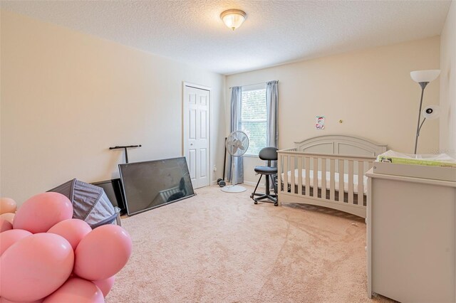 1639 Balsam Willow Trl, Orlando, FL 32825 - carpeted bedroom with a closet, a textured ceiling, and a nursery area