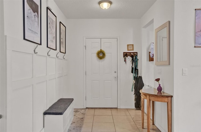 2216 Sequoia Way, Davenport, FL 33896 - mudroom featuring light tile patterned flooring and a textured ceiling