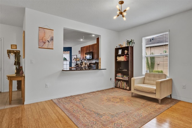 2216 Sequoia Way, Davenport, FL 33896 - living area with light wood-style flooring and a chandelier