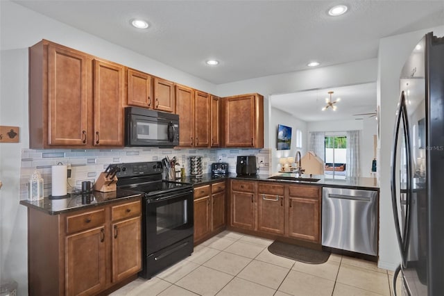 2216 Sequoia Way, Davenport, FL 33896 - kitchen with black appliances, backsplash, brown cabinets, light tile patterned floors, and recessed lighting