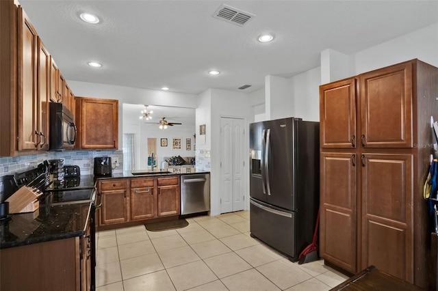 2216 Sequoia Way, Davenport, FL 33896 - kitchen with stainless steel appliances, backsplash, light tile patterned floors, dark stone countertops, and recessed lighting