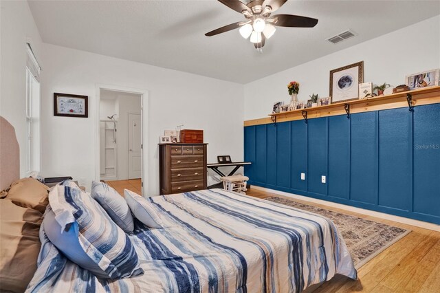 2216 Sequoia Way, Davenport, FL 33896 - bedroom featuring wood finished floors, a ceiling fan, and connected bathroom