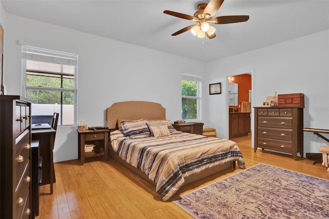 2216 Sequoia Way, Davenport, FL 33896 - bedroom featuring light wood-type flooring, connected bathroom, and ceiling fan