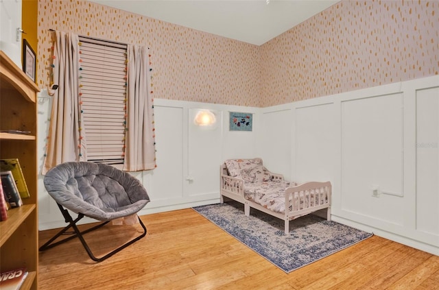 2216 Sequoia Way, Davenport, FL 33896 - sitting room with wallpapered walls, a decorative wall, a wainscoted wall, and wood finished floors