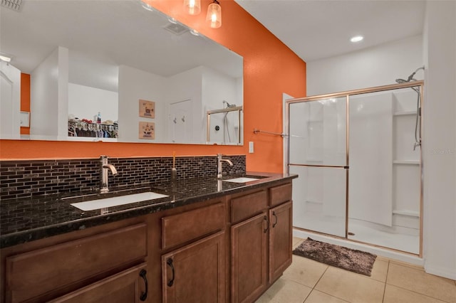 2216 Sequoia Way, Davenport, FL 33896 - bathroom featuring a stall shower, tasteful backsplash, tile patterned floors, double vanity, and a walk in closet