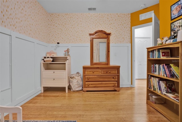 2216 Sequoia Way, Davenport, FL 33896 - sitting room featuring wallpapered walls, a wainscoted wall, wood finished floors, and a decorative wall