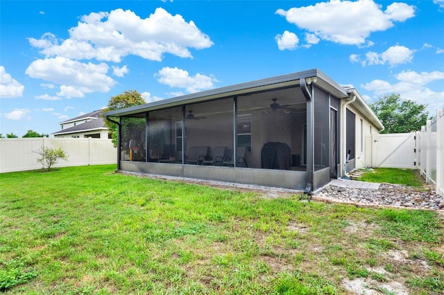 2216 Sequoia Way, Davenport, FL 33896 - rear view of house with a sunroom, ceiling fan, a gate, and a fenced backyard