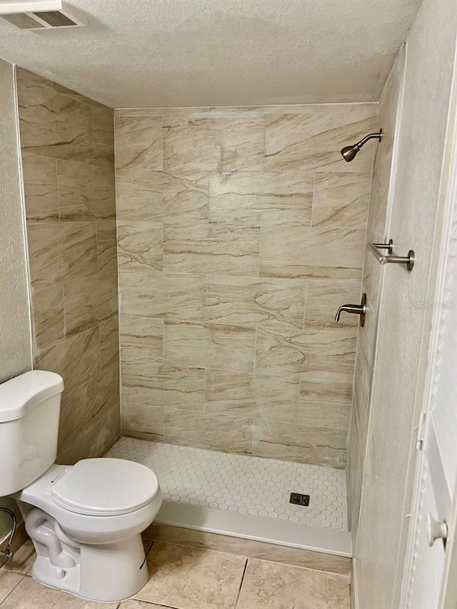 4606 Commander Dr Unit 1126, Orlando, FL 32822 - full bath with a stall shower, a textured ceiling, and tile patterned floors