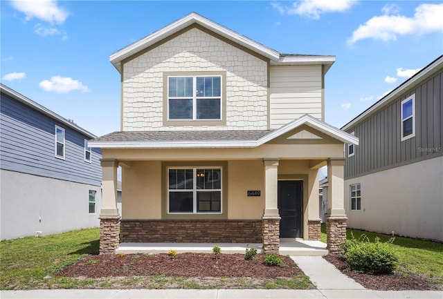 6449 Sprucepine Ln, Saint Cloud, FL 34771 - craftsman house featuring covered porch, roof with shingles, and stone siding