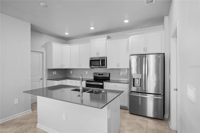 6449 Sprucepine Ln, Saint Cloud, FL 34771 - kitchen featuring stainless steel appliances, backsplash, white cabinets, an island with sink, and recessed lighting