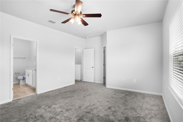 6449 Sprucepine Ln, Saint Cloud, FL 34771 - unfurnished bedroom with carpet floors, ensuite bath, and ceiling fan