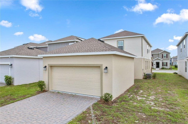 6449 Sprucepine Ln, Saint Cloud, FL 34771 - view of property exterior with roof with shingles, a garage, decorative driveway, a lawn, and a residential view