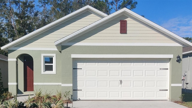 3349 Wynwood Forest Dr, Ocoee, FL 34761 - view of front of property with a garage, stucco siding, and concrete driveway