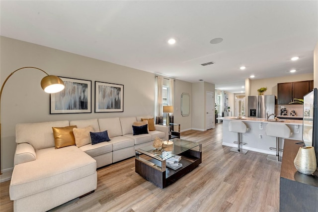 3349 Wynwood Forest Dr, Ocoee, FL 34761 - living room featuring light wood-style flooring and recessed lighting