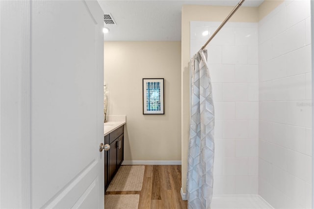 3349 Wynwood Forest Dr, Ocoee, FL 34761 - full bath featuring vanity, wood finished floors, and a tile shower