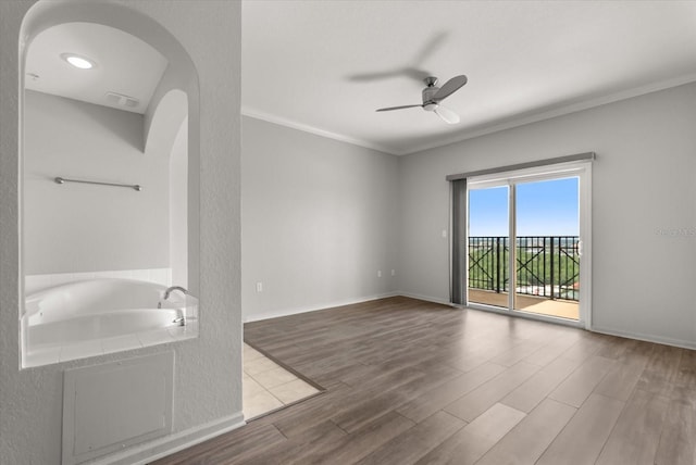 8101 Resort Village Dr Unit 31503, Orlando, FL 32821 - spare room featuring a ceiling fan, wood finished floors, arched walkways, and crown molding
