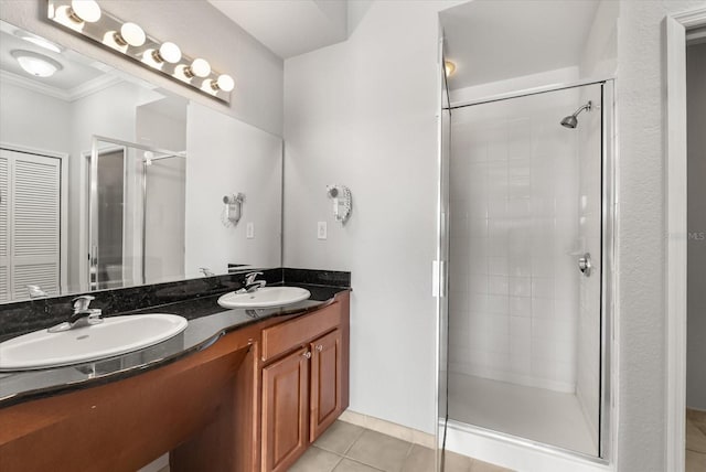 8101 Resort Village Dr Unit 31503, Orlando, FL 32821 - bathroom with crown molding, a stall shower, double vanity, and tile patterned flooring