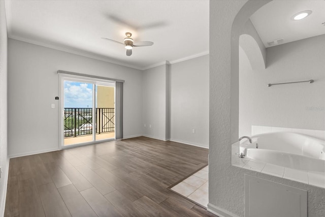 8101 Resort Village Dr Unit 31503, Orlando, FL 32821 - unfurnished living room featuring arched walkways, ceiling fan, wood finished floors, and crown molding