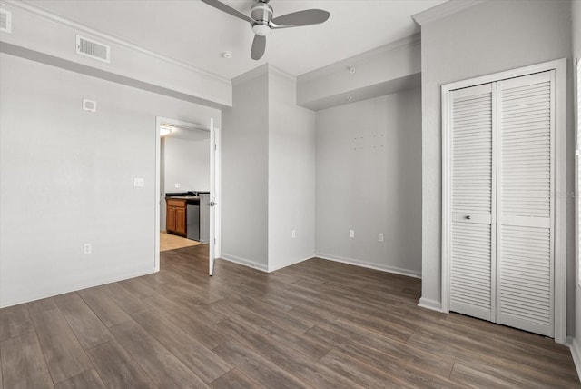 8101 Resort Village Dr Unit 31503, Orlando, FL 32821 - unfurnished bedroom with ornamental molding, dark wood finished floors, a closet, and a ceiling fan