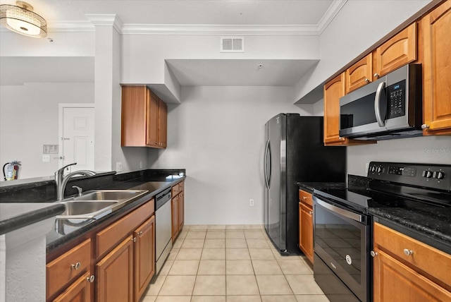 8101 Resort Village Dr Unit 31503, Orlando, FL 32821 - kitchen with appliances with stainless steel finishes, crown molding, dark countertops, light tile patterned floors, and brown cabinets