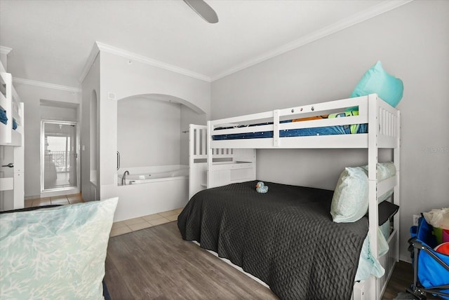 8101 Resort Village Dr Unit 31503, Orlando, FL 32821 - bedroom with ornamental molding, arched walkways, wood finished floors, and ceiling fan