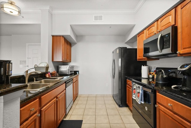 8101 Resort Village Dr Unit 31503, Orlando, FL 32821 - kitchen with appliances with stainless steel finishes, ornamental molding, light tile patterned floors, and brown cabinetry