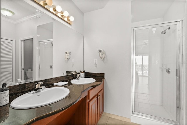 8101 Resort Village Dr Unit 31503, Orlando, FL 32821 - bathroom with a shower stall, double vanity, tile patterned floors, and crown molding