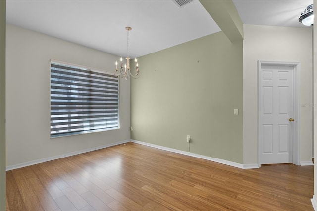 3533 Somerset Cir, Kissimmee, FL 34746 - spare room featuring a chandelier and wood finished floors