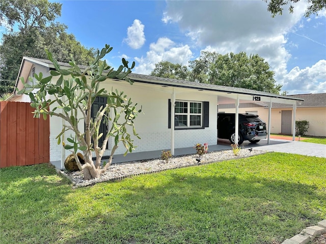 1428 Glendale St, Lakeland, FL 33803 - view of front of home featuring a carport, brick siding, and concrete driveway