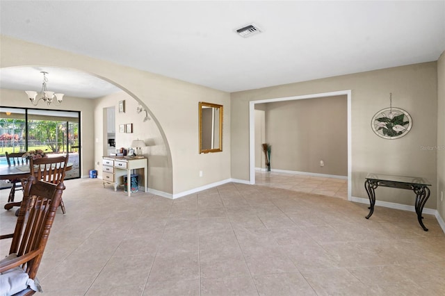 2113 Lochmoor Cir, North Fort Myers, FL 33903 - dining room with a chandelier, arched walkways, and light tile patterned flooring