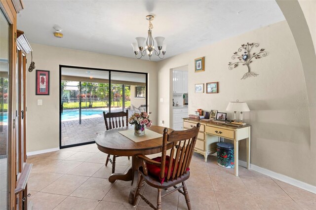 2113 Lochmoor Cir, North Fort Myers, FL 33903 - dining space with light tile patterned floors and a chandelier