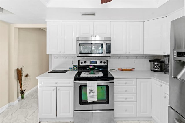 2113 Lochmoor Cir, North Fort Myers, FL 33903 - kitchen featuring stainless steel appliances, light countertops, tasteful backsplash, and white cabinets