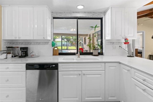 2113 Lochmoor Cir, North Fort Myers, FL 33903 - kitchen featuring stainless steel dishwasher, backsplash, and white cabinetry