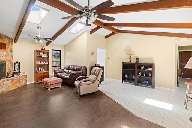 2113 Lochmoor Cir, North Fort Myers, FL 33903 - living area featuring ceiling fan, a skylight, wood finished floors, and a stone fireplace