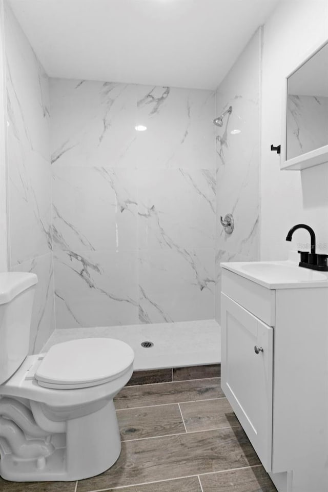 2113 Lochmoor Cir, North Fort Myers, FL 33903 - full bathroom featuring vanity, a marble finish shower, and wood finished floors