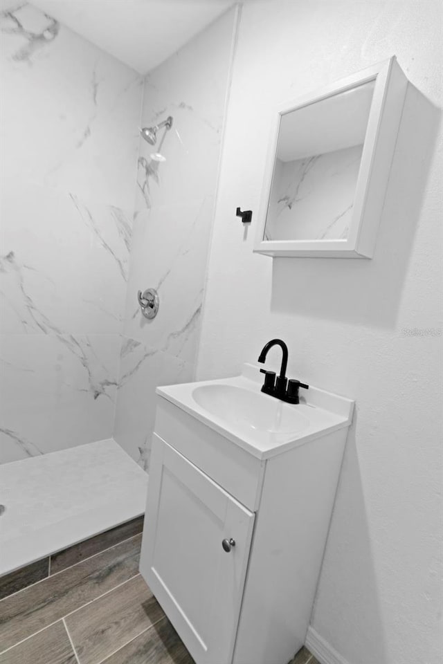 2113 Lochmoor Cir, North Fort Myers, FL 33903 - full bathroom featuring vanity, a marble finish shower, and wood finished floors