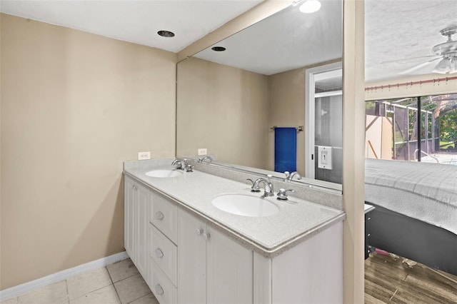 2113 Lochmoor Cir, North Fort Myers, FL 33903 - full bath with double vanity, tile patterned flooring, and ceiling fan