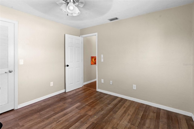 2113 Lochmoor Cir, North Fort Myers, FL 33903 - unfurnished bedroom featuring dark wood-type flooring and ceiling fan