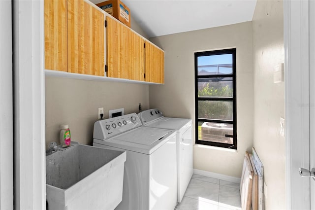 2113 Lochmoor Cir, North Fort Myers, FL 33903 - laundry area featuring cabinet space, light marble finish floors, and washing machine and clothes dryer
