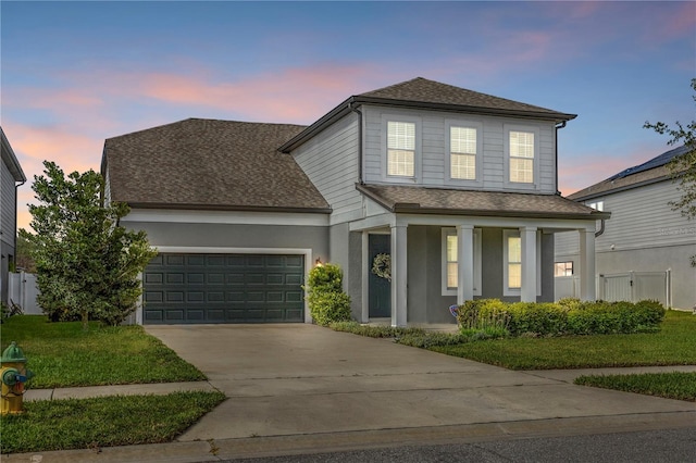 840 Livestock Loop, Saint Cloud, FL 34771 - traditional home with a shingled roof, a garage, concrete driveway, and covered porch