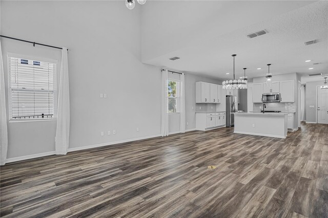 840 Livestock Loop, Saint Cloud, FL 34771 - unfurnished living room featuring dark wood-type flooring, recessed lighting, and a chandelier