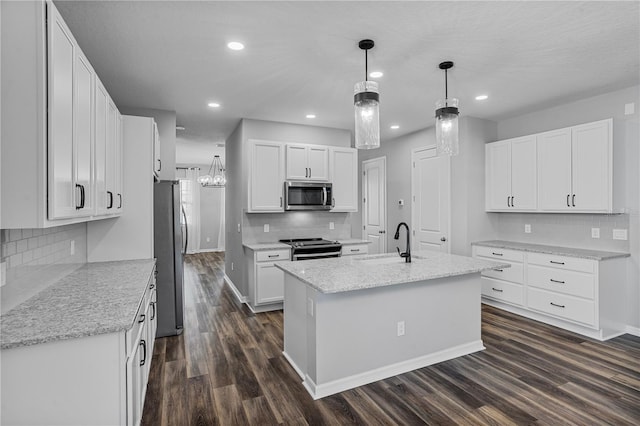 840 Livestock Loop, Saint Cloud, FL 34771 - kitchen featuring appliances with stainless steel finishes, dark wood finished floors, tasteful backsplash, white cabinetry, and recessed lighting