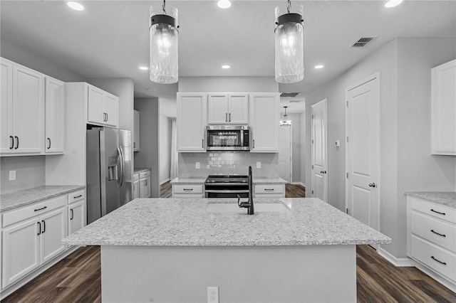 840 Livestock Loop, Saint Cloud, FL 34771 - kitchen featuring stainless steel appliances, recessed lighting, white cabinetry, and dark wood finished floors